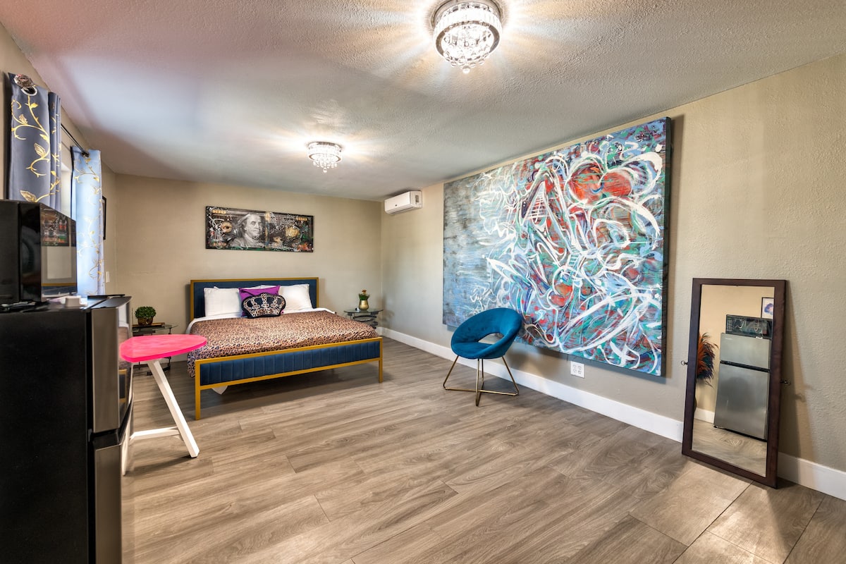 Bedroom with a large mirror, artwork and television at Spencer Dream Estate