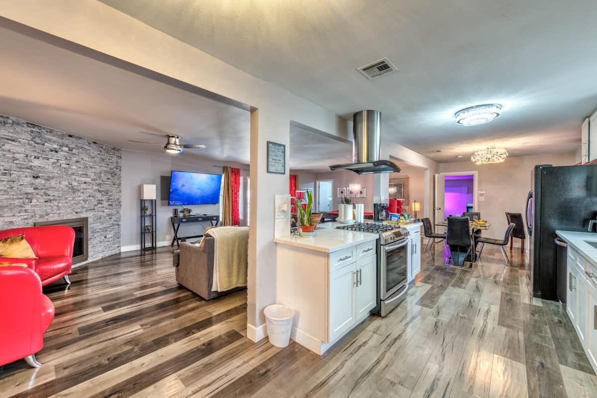 Open kitchen with a breakfast bar and dining area at Cashman Dream House