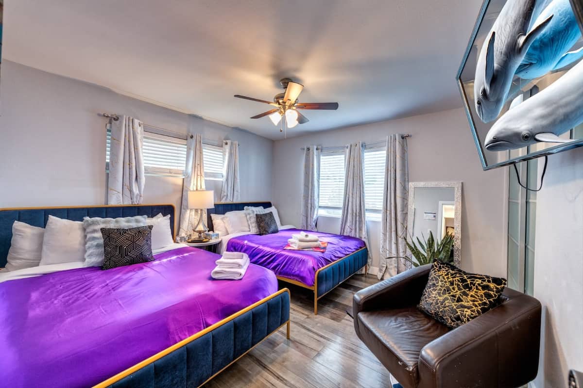 Bedroom with two beds and a sofa at Cashman Dream House in Las Vegas