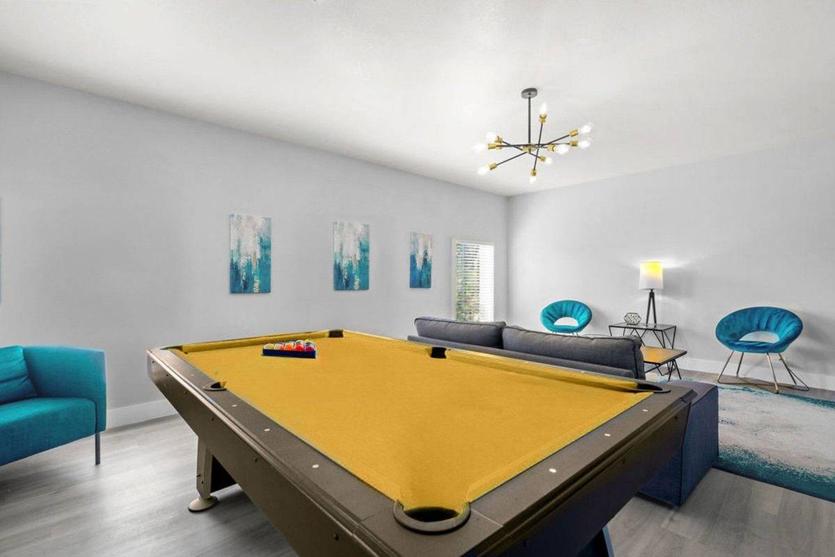 Shared room with a pool table and lounge chairs at Pama Lane in Las Vegas