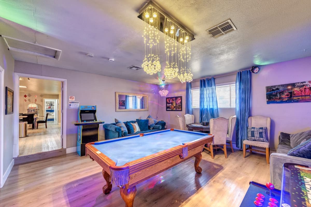 Game room with pool table and arcade games at Spencer Dream Estate