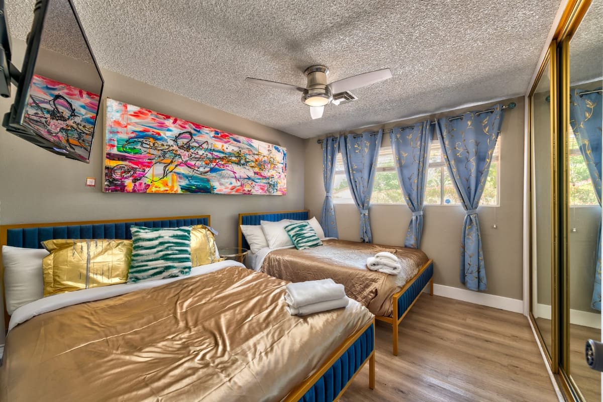 Bedroom with two beds and gold accents at Spencer Dream Estate in Las Vegas