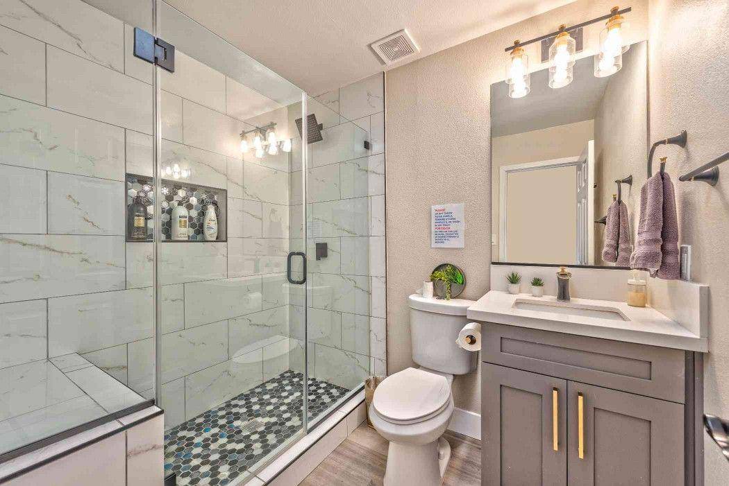 Shared bathroom with a glass walk-in shower and vanity at Pama Lane