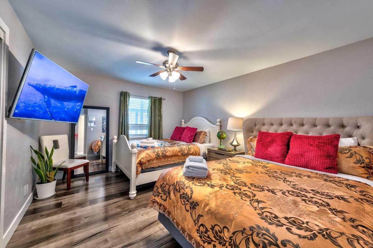 Bedroom with two beds and a wall-mounted television at Cashman Dream House