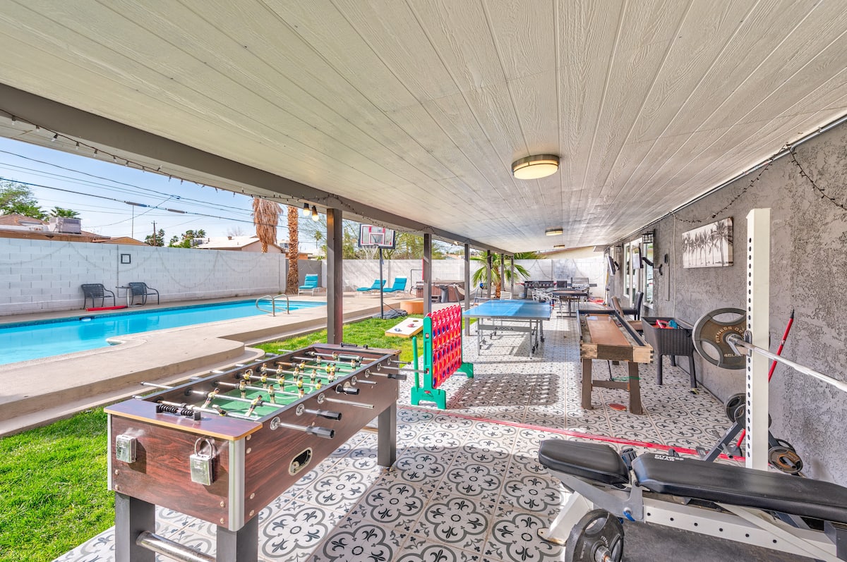 Covered patio game area with a foosball table at Cashman Dream House
