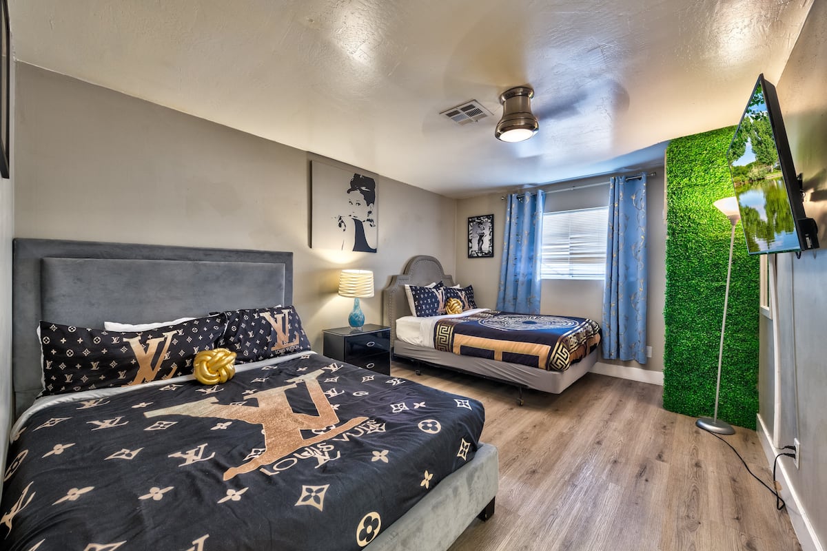 Bedroom with a green accent wall and two beds at Spencer Dream Estate